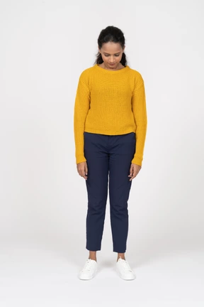 Front view of a beautiful girl in casual clothes looking down