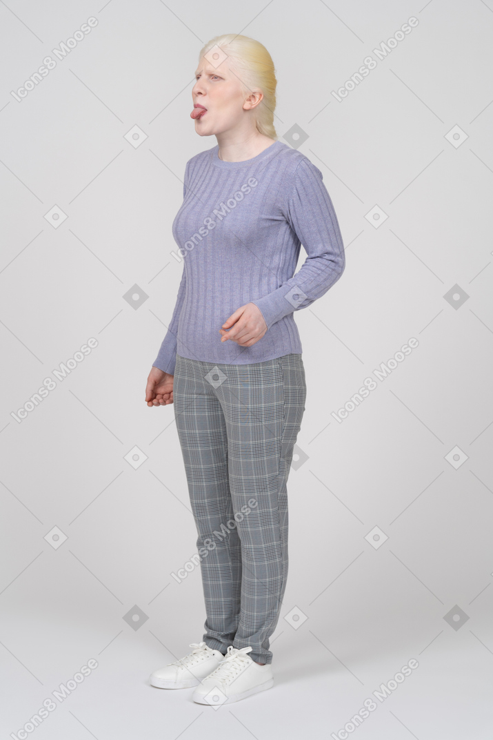 Woman in casual clothes sticking her tongue out