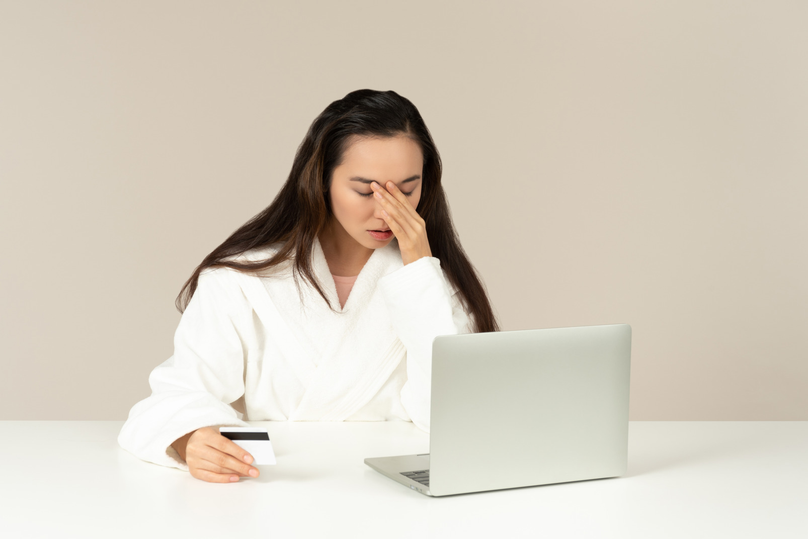 Young asian woman looking upset while doing online shopping