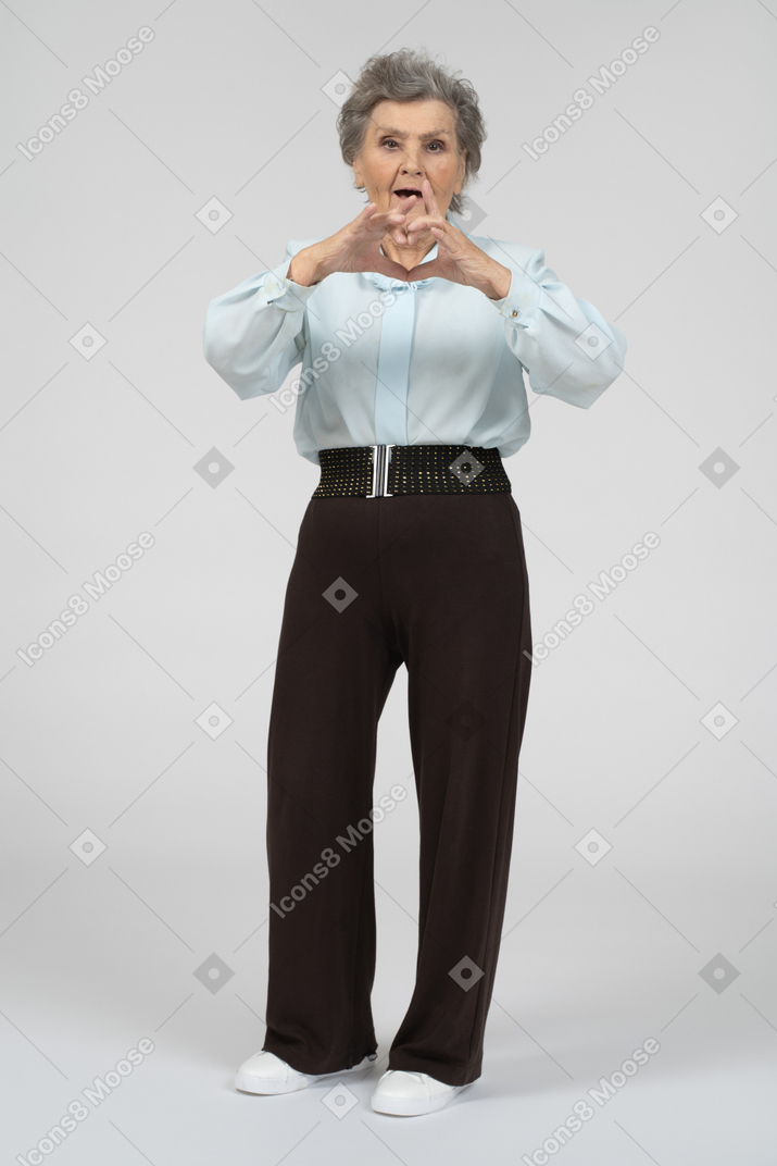 Old lady giving heart sign