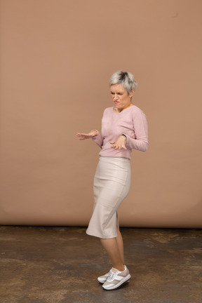Side view of an emotional woman in casual clothes showing stop gesture