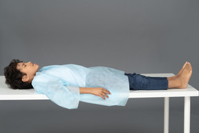 Boy lying down in profile