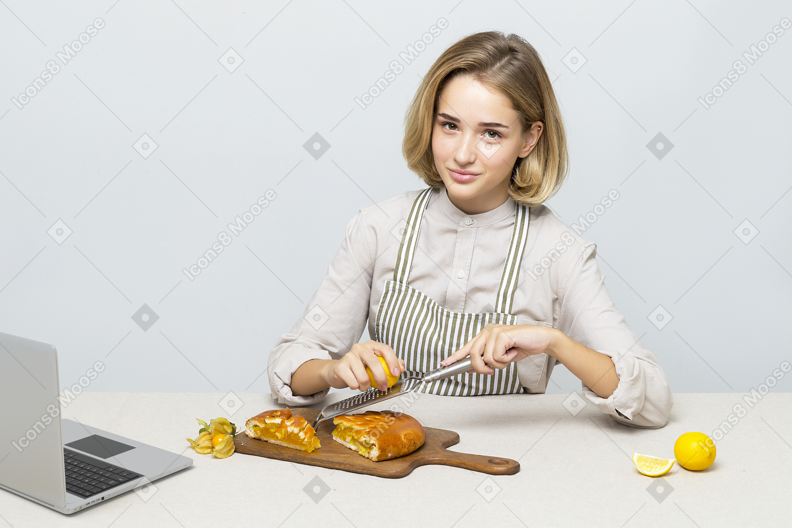 Attractive girl cooking a lemon pie while watching online video