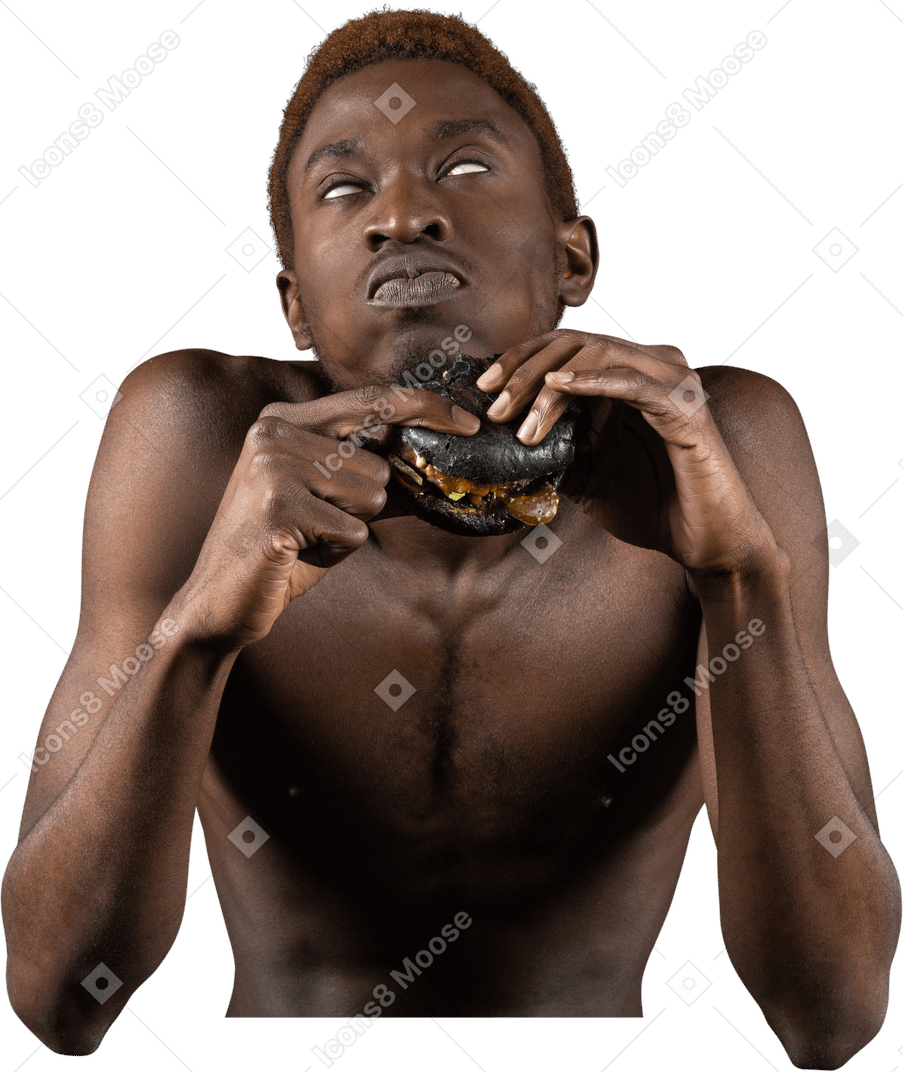 Front view of a young afro man biting a burger while rolling eyes