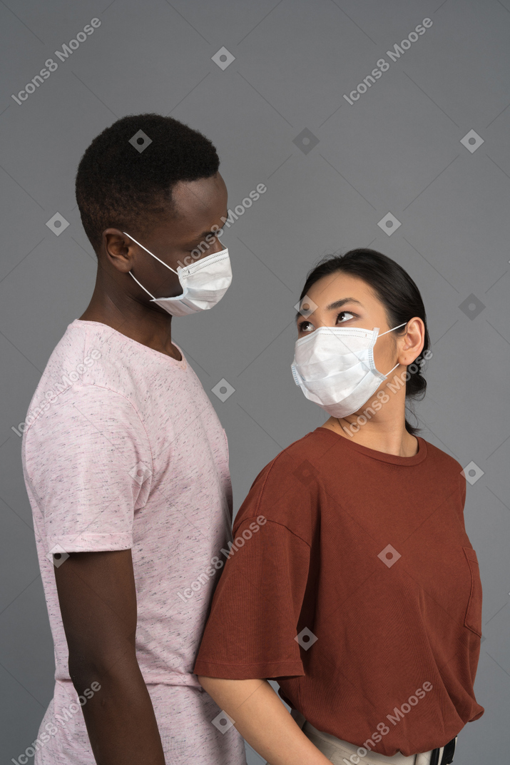 A young couple wearing medical masks