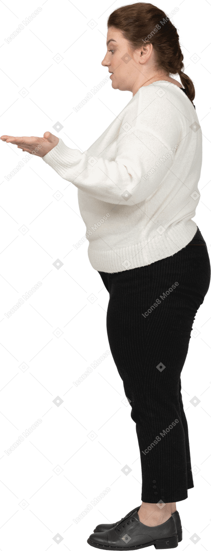 Side view of a plump woman in casual clothes saying something