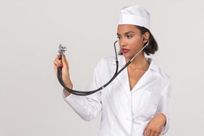 Attractive young female doctor holding a stethoscope