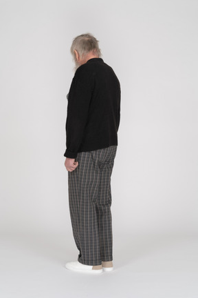 Three quarter back view of an old man turning head