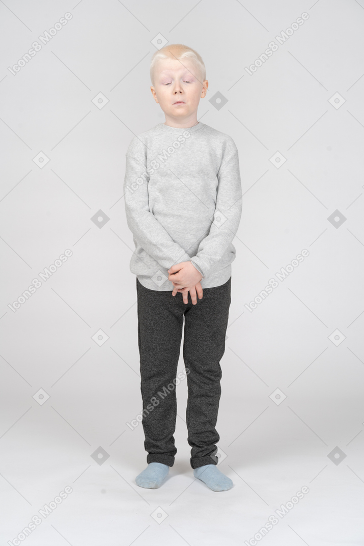 Front view of a displeased kid boy