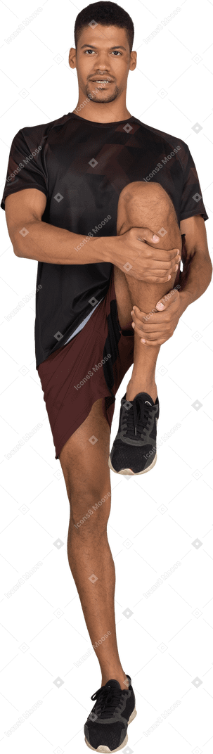 Young man in sports clothes stretching