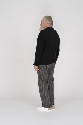Back view of an old man standing and smiling