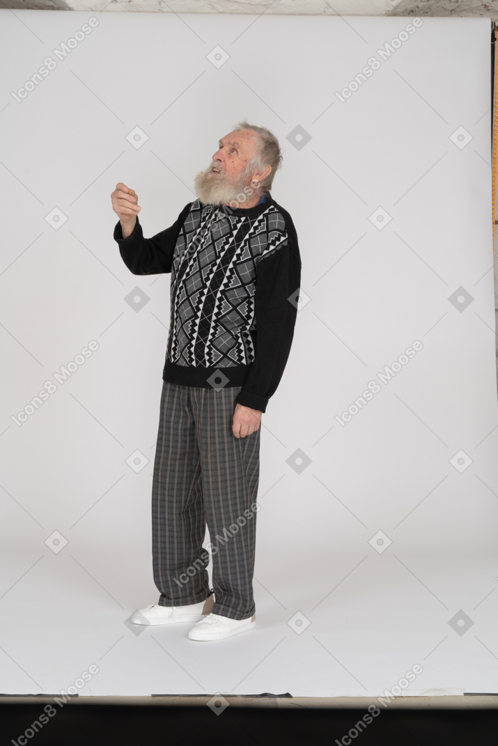 Old man looking up with raised arm