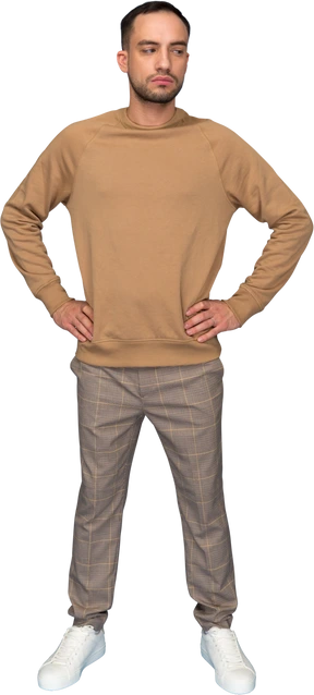 Young man standing with hands akimbo