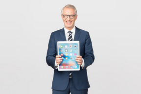 Elegant middle-aged business man showing his tablet