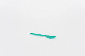 Plastic green fork on a white background