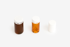 Three plastic pill bottles