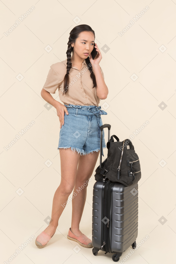 Asian female tourist speaking on the phone