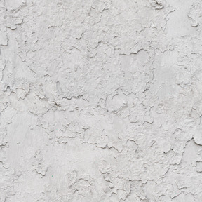 Vieja capa de pintura agrietada sobre muro de hormigón