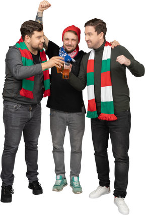 Front view of three  male football fans celebrating the victory