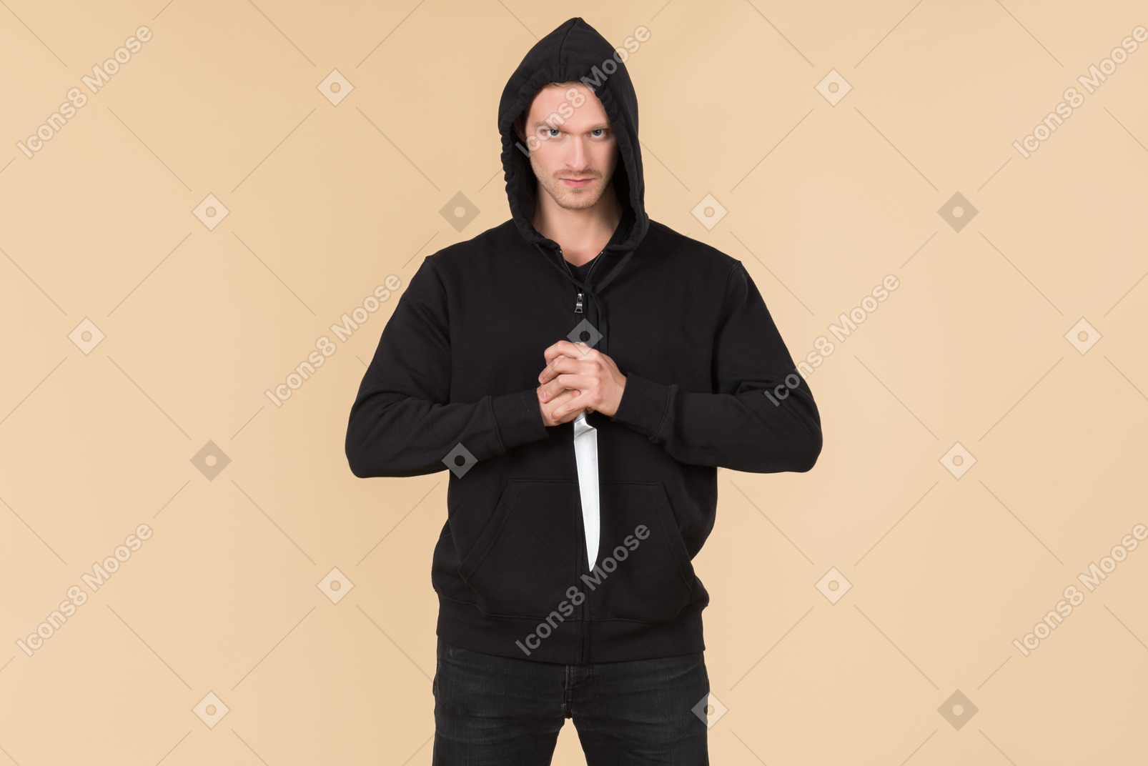 Criminal with hood on holding a knife