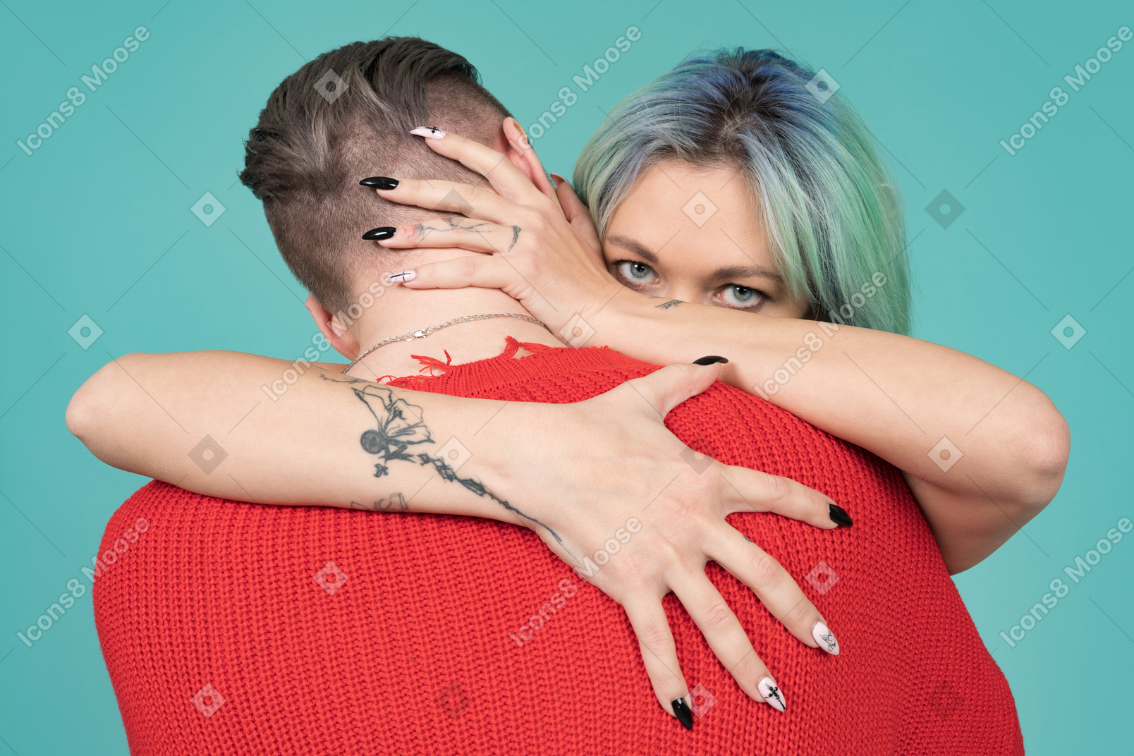 Turquoise haired young woman hugging her man and facing camera