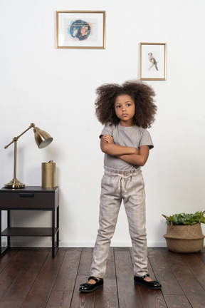 Good looking girl kid posing on the apartment background