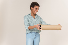 A woman holding a roll of paper and smiling