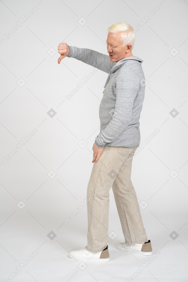 Side view of man giving thumbs down
