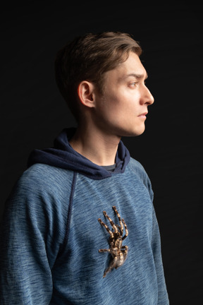 Young man with tarantula on his chest