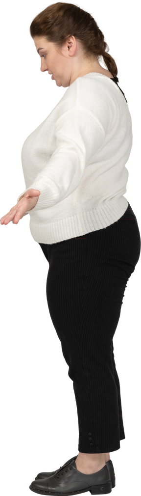Side view of a plump woman in casual clothes saying something