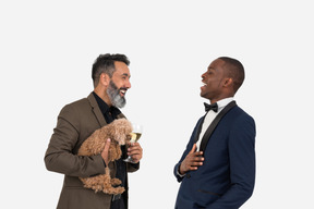 Afroman talking to hispanic mature man which holding a pet