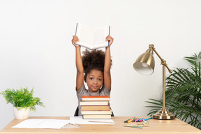 Good looking cute girl with books at the table