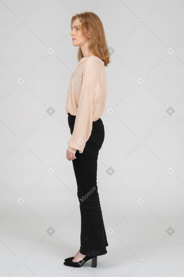 Side view of redhead woman standing