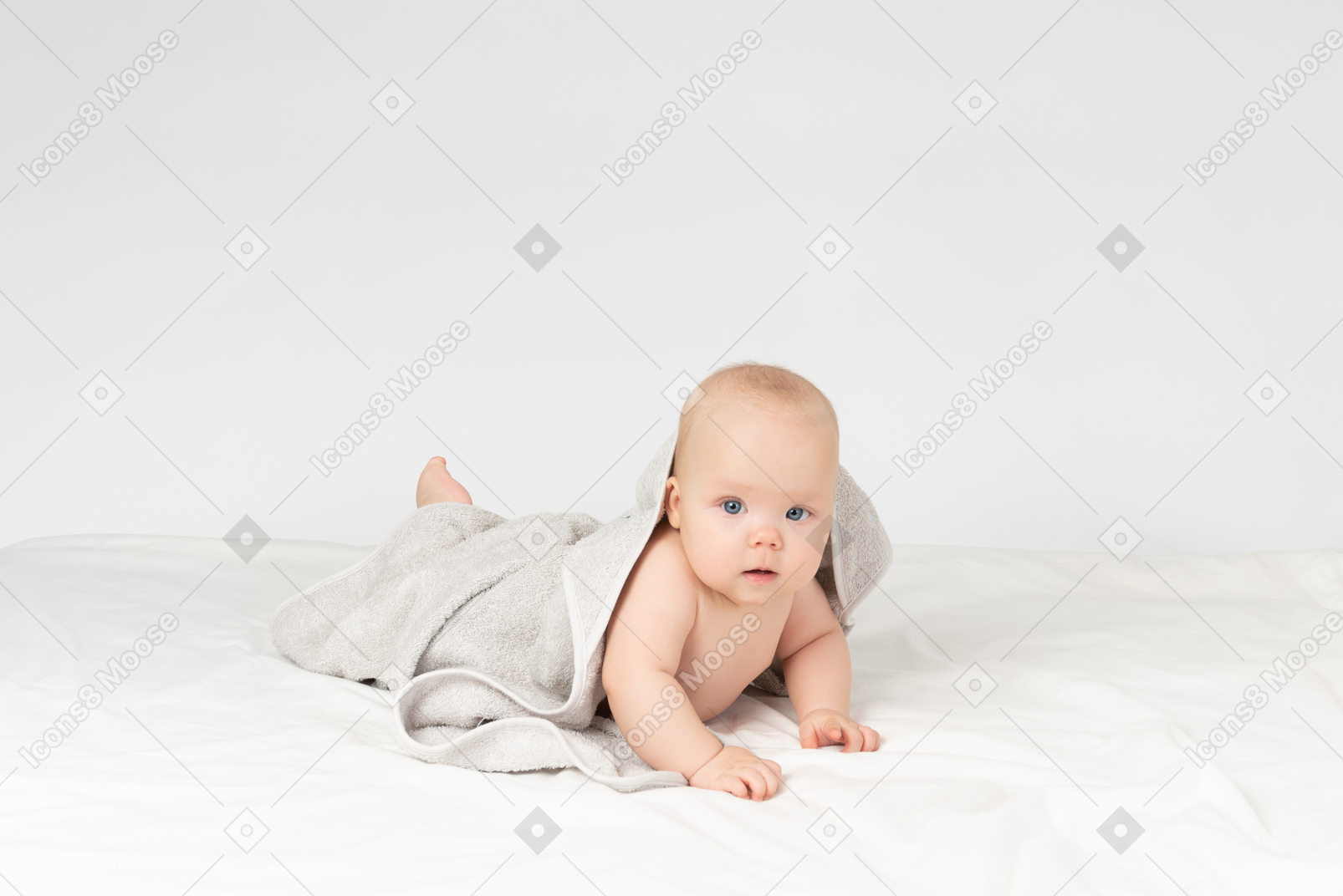 Baby girl covered in grey towel
