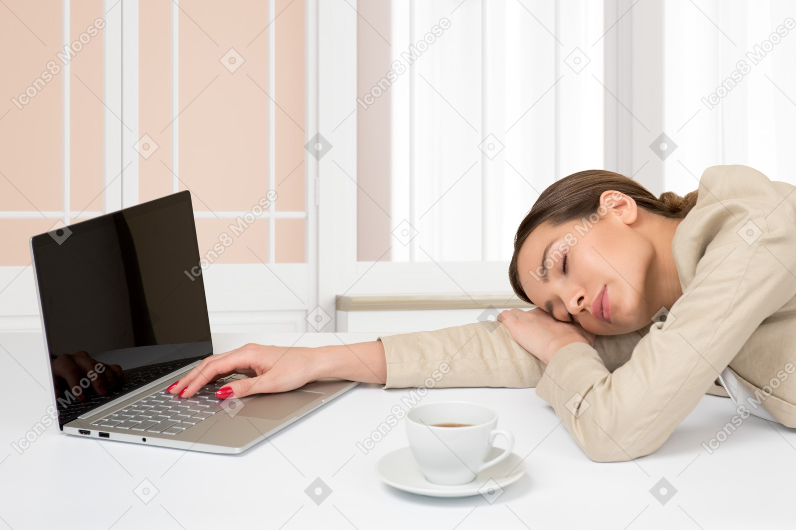 Woman sleeping at the desk in front of laptop in the office