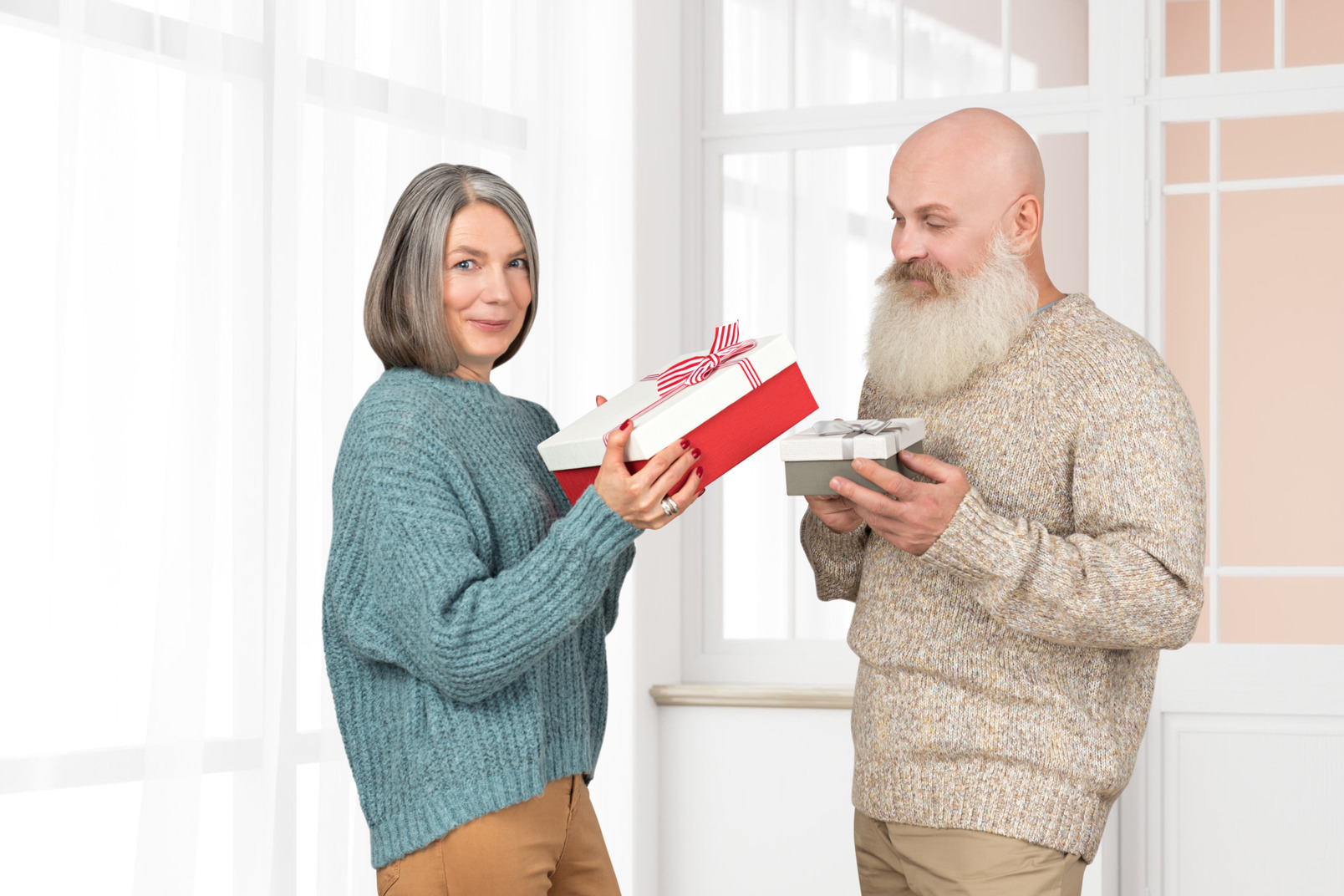 Senior woman giving a christmas gift to her husband