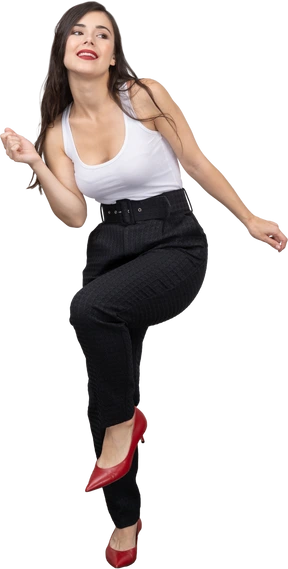 Full-length of a smiling young female in office clothing dancing