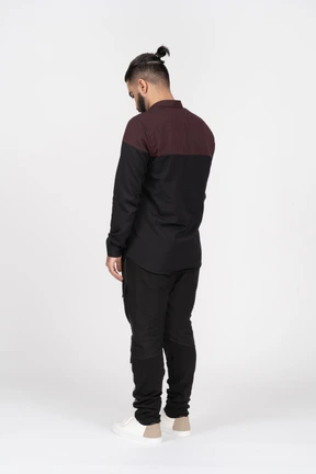 A young man standing backwards