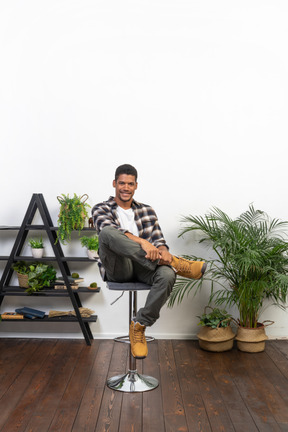 Good looking young man sitting on a chair