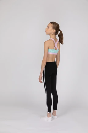Side view of a teen girl in sportswear raising hand and arguing