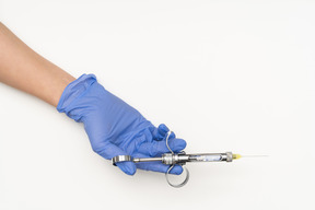 Female hand holding a syringe