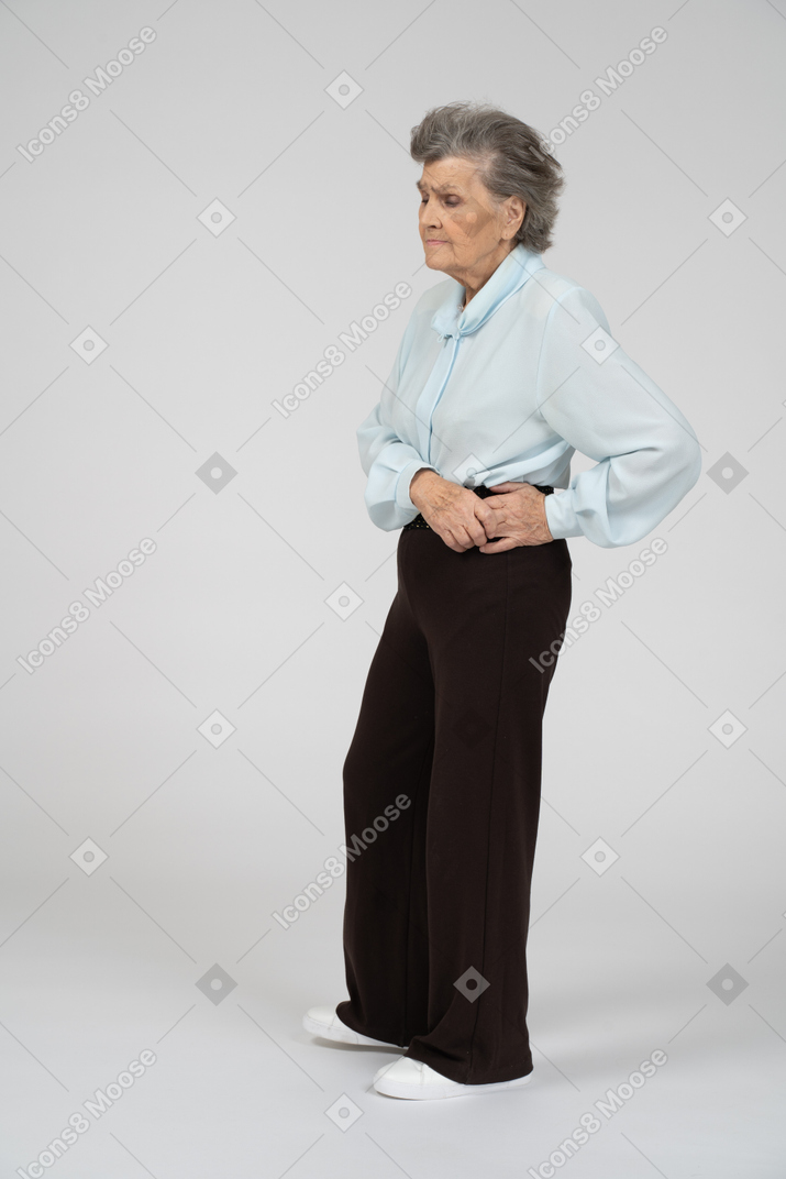 Вид сбоку на пожилую женщину, выглядящую меланхоличной