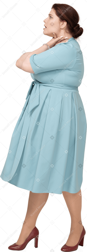 Side view of a woman in blue dress chocking herself