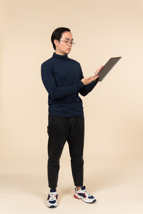 Young asian man presenting a digital tablet