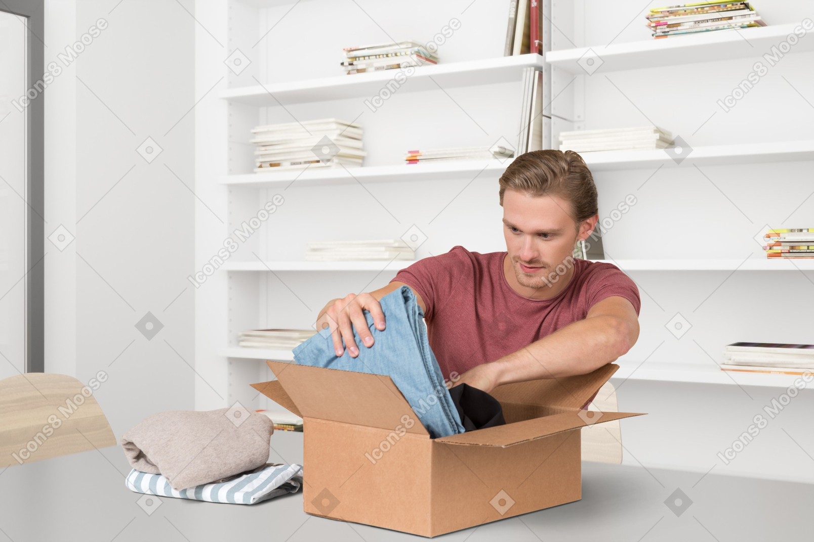 A man opening a box with a pair of jeans in it