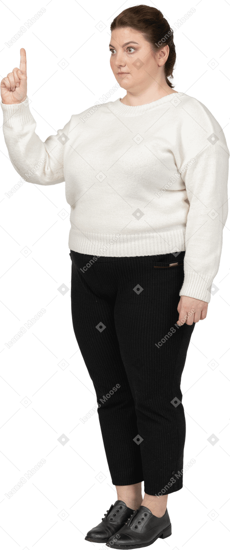 Plump woman in casual clothes pointing up with a finger
