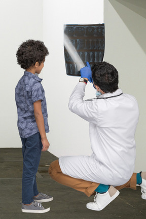 A man showing an x-ray to a little boy