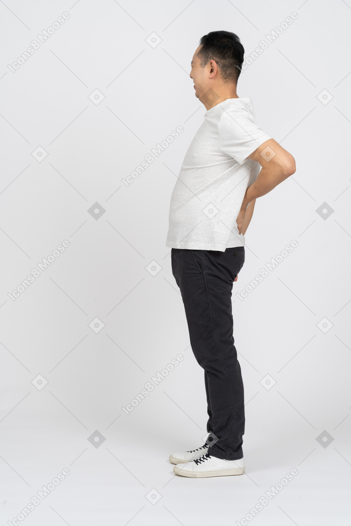 Side view of a man suffering from back pain