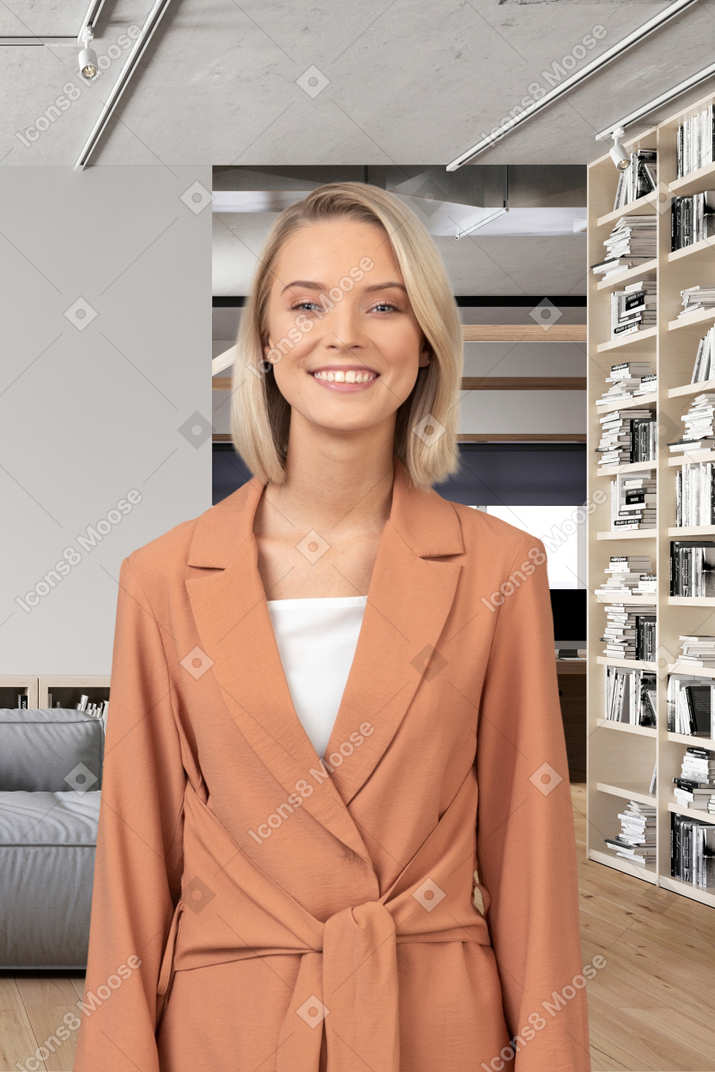A woman standing in front of a bookshelf