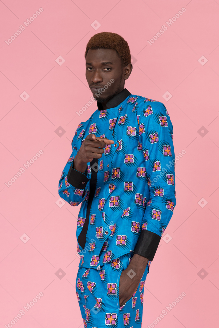 Homem negro de pijama azul apontando